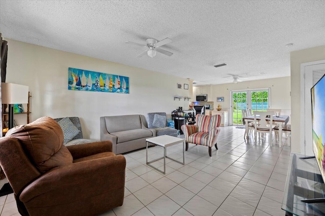 19309 Carolina Cir, Boca Raton, FL 33434 - living room with a ceiling fan, a textured ceiling, and light tile patterned floors