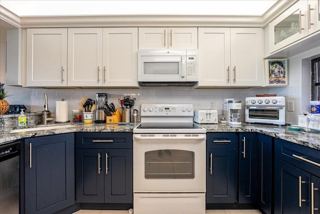 1102 SE Mitchell Ave Unit 302, Port Saint Lucie, FL 34952 - kitchen featuring white appliances, blue cabinets, white cabinetry, tasteful backsplash, and light stone countertops
