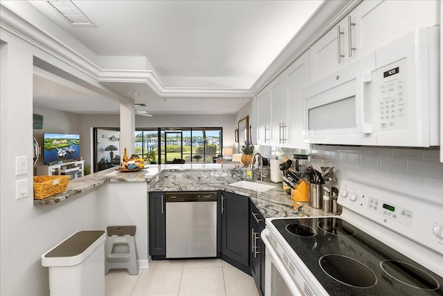 1102 SE Mitchell Ave Unit 302, Port Saint Lucie, FL 34952 - kitchen featuring white appliances, light tile patterned floors, white cabinets, and light stone countertops