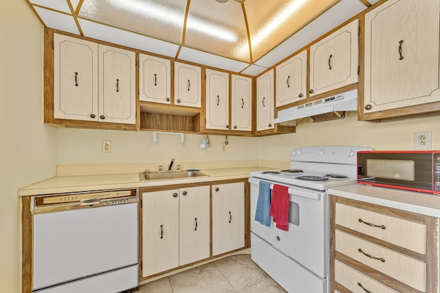 501 Normandy K, Delray Beach, FL 33484 - kitchen with white appliances, under cabinet range hood, light countertops, and light tile patterned floors