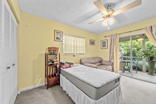 501 Normandy K, Delray Beach, FL 33484 - bedroom featuring carpet floors, a closet, access to outside, a textured ceiling, and ceiling fan
