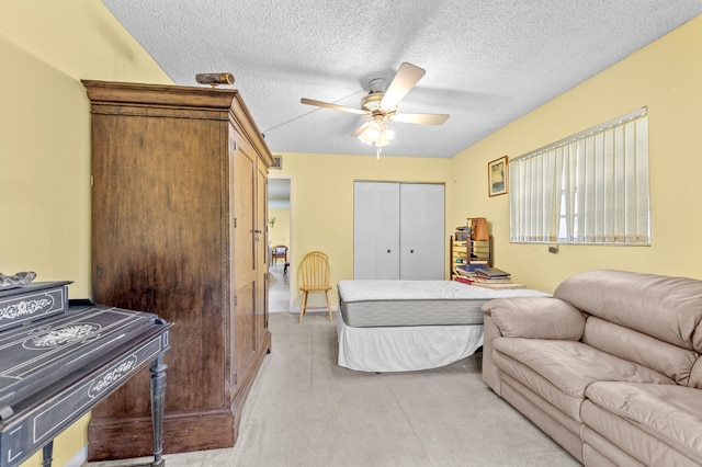 501 Normandy K, Delray Beach, FL 33484 - bedroom with light colored carpet, a closet, a textured ceiling, and a ceiling fan