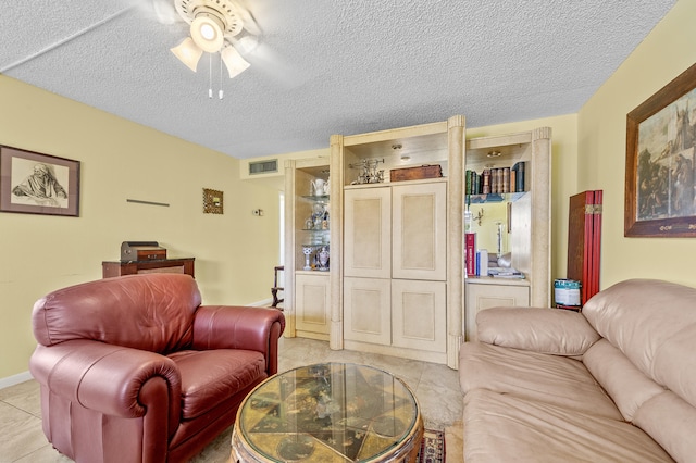 501 Normandy K, Delray Beach, FL 33484 - living area with ceiling fan, light tile patterned floors, and a textured ceiling