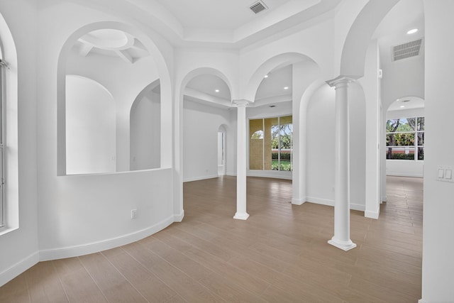 8873 Via Brilliante, Wellington, FL 33411 - entryway featuring plenty of natural light, recessed lighting, wood finished floors, and decorative columns