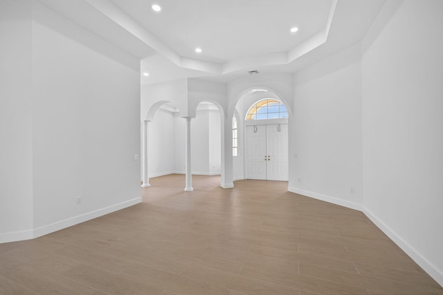 8873 Via Brilliante, Wellington, FL 33411 - entrance foyer with recessed lighting, light wood-style flooring, a tray ceiling, and arched walkways