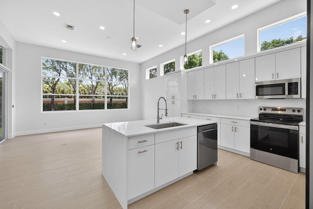 8873 Via Brilliante, Wellington, FL 33411 - kitchen featuring stainless steel appliances, recessed lighting, light countertops, white cabinetry, and decorative light fixtures