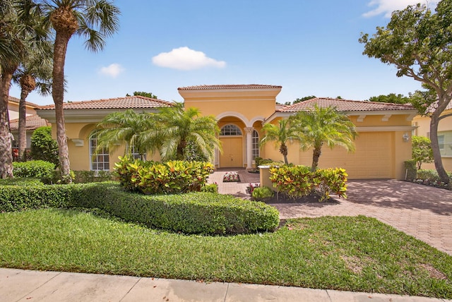 8873 Via Brilliante, Wellington, FL 33411 - mediterranean / spanish house with stucco siding, decorative driveway, a garage, and a tiled roof