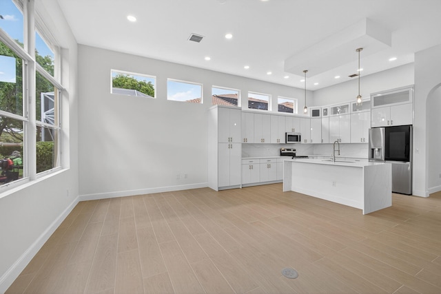 8873 Via Brilliante, Wellington, FL 33411 - kitchen featuring stainless steel appliances, light countertops, white cabinets, recessed lighting, and pendant lighting