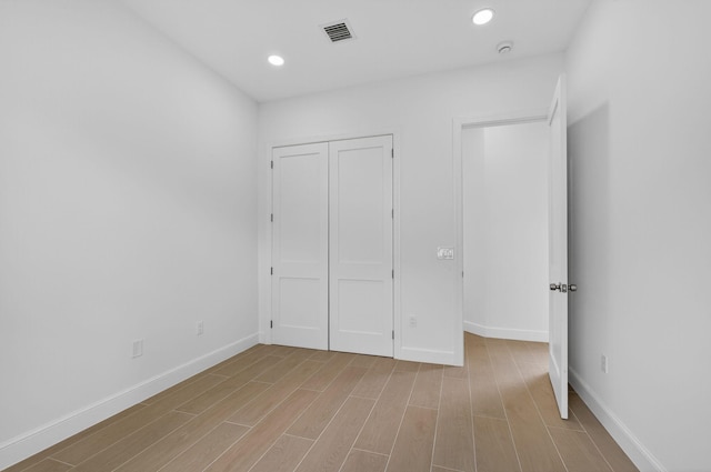 8873 Via Brilliante, Wellington, FL 33411 - unfurnished bedroom featuring light wood finished floors, recessed lighting, and a closet