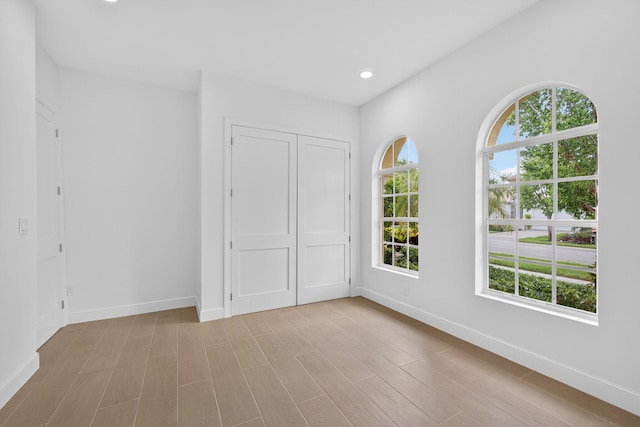 8873 Via Brilliante, Wellington, FL 33411 - unfurnished bedroom with wood finished floors, a closet, and recessed lighting
