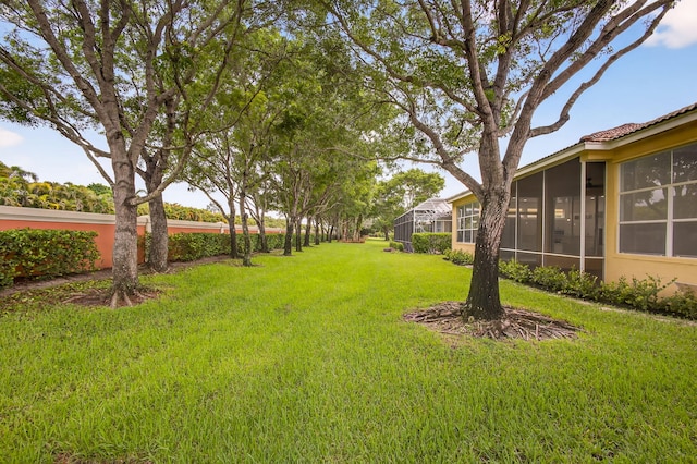 8873 Via Brilliante, Wellington, FL 33411 - view of grassy yard featuring a sunroom
