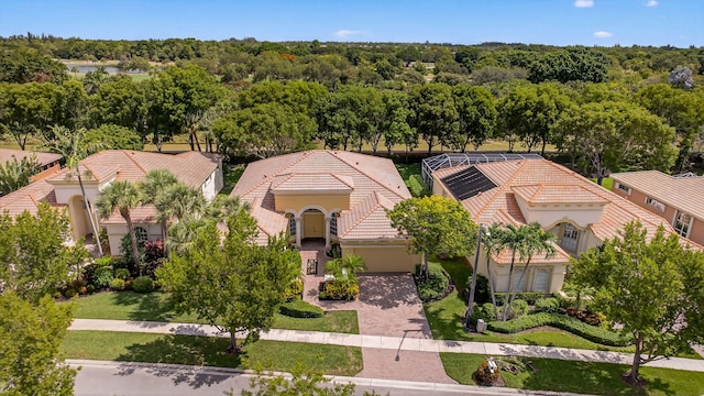 8873 Via Brilliante, Wellington, FL 33411 - view of front of house featuring a tile roof, stucco siding, a garage, and driveway