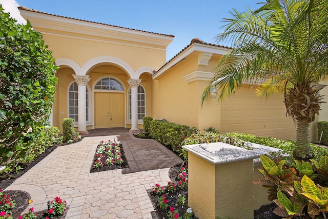 8873 Via Brilliante, Wellington, FL 33411 - doorway to property featuring stucco siding, an attached garage, and a tile roof