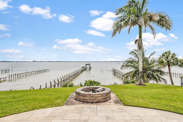 671 Indian River Dr, Melbourne, FL 32935 - view of patio featuring an outdoor fire pit, a water view, and a boat dock