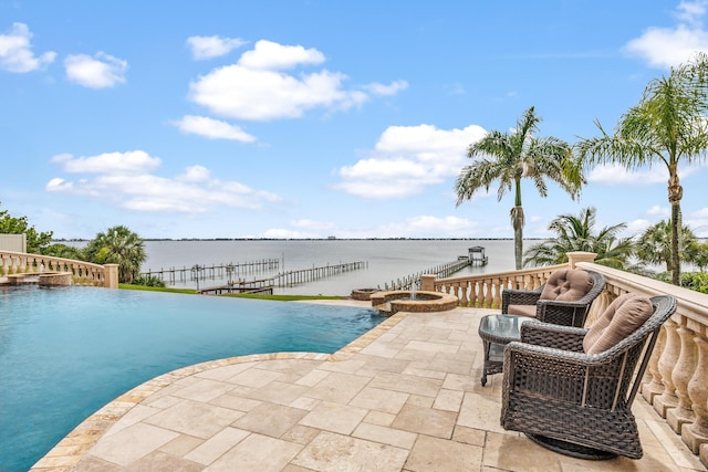671 Indian River Dr, Melbourne, FL 32935 - view of pool with a pool with connected hot tub, a water view, and a patio area