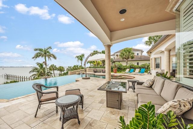 671 Indian River Dr, Melbourne, FL 32935 - view of patio featuring an outdoor hangout area, an infinity pool, and a water view