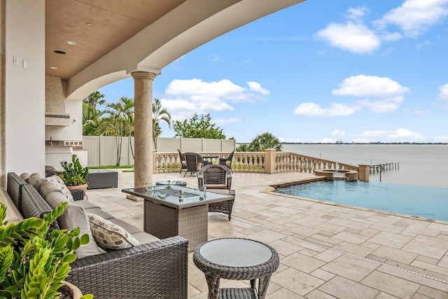 671 Indian River Dr, Melbourne, FL 32935 - view of patio / terrace featuring outdoor lounge area, a pool with connected hot tub, a water view, and area for grilling