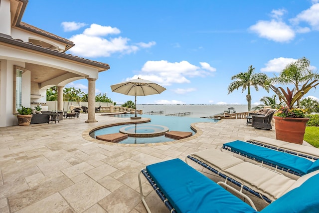 671 Indian River Dr, Melbourne, FL 32935 - view of pool with a patio, an outdoor hangout area, a water view, and a pool with connected hot tub