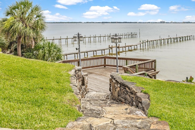 671 Indian River Dr, Melbourne, FL 32935 - dock area with a water view and a yard