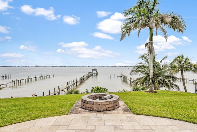 671 Indian River Dr, Melbourne, FL 32935 - view of patio featuring an outdoor fire pit, a water view, and a boat dock