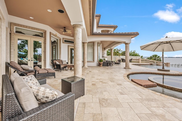 671 Indian River Dr, Melbourne, FL 32935 - view of patio / terrace featuring french doors, an outdoor living space, and a ceiling fan