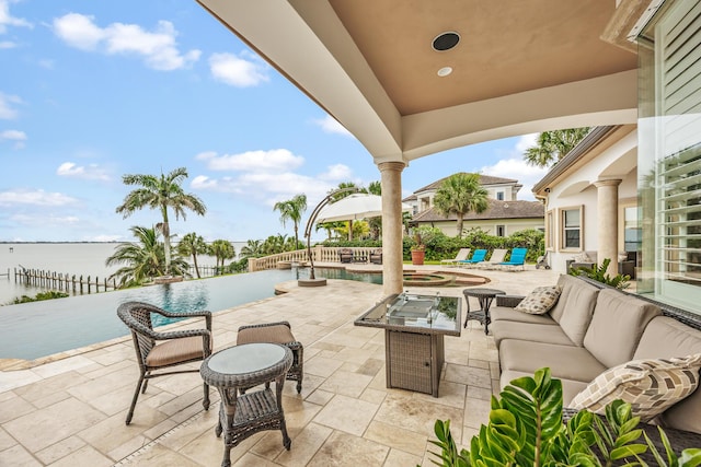 671 Indian River Dr, Melbourne, FL 32935 - view of patio featuring an outdoor living space, an outdoor pool, and a water view