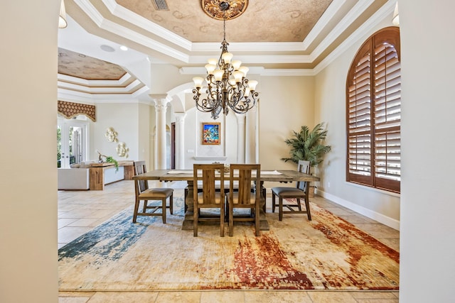 671 Indian River Dr, Melbourne, FL 32935 - tiled dining space featuring a raised ceiling, a chandelier, crown molding, ornate columns, and arched walkways