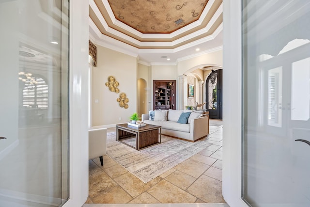 671 Indian River Dr, Melbourne, FL 32935 - living area with arched walkways, crown molding, and a tray ceiling