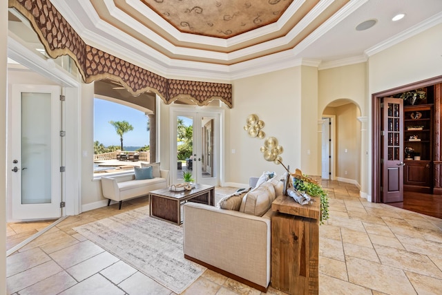 671 Indian River Dr, Melbourne, FL 32935 - living area featuring arched walkways, crown molding, a raised ceiling, a towering ceiling, and french doors
