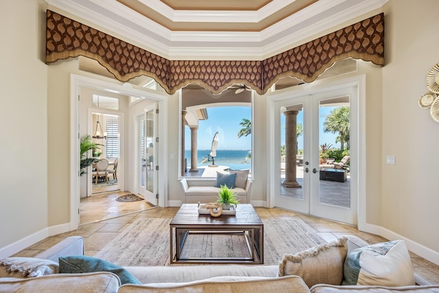 671 Indian River Dr, Melbourne, FL 32935 - living room featuring french doors, crown molding, healthy amount of natural light, a water view, and stone tile floors