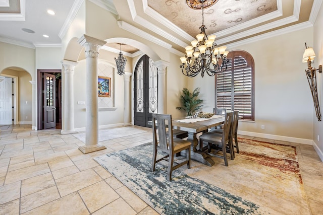 671 Indian River Dr, Melbourne, FL 32935 - dining space featuring a chandelier, arched walkways, a raised ceiling, ornate columns, and ornamental molding