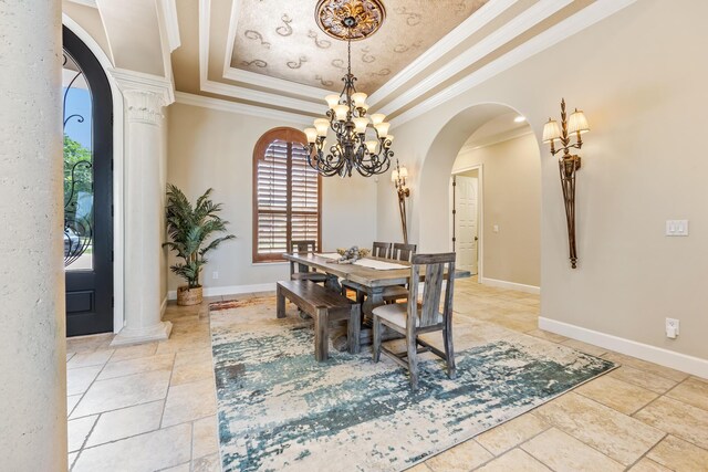 671 Indian River Dr, Melbourne, FL 32935 - dining space with arched walkways, a tray ceiling, a chandelier, ornamental molding, and decorative columns