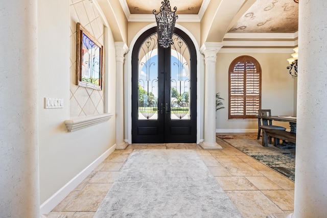 671 Indian River Dr, Melbourne, FL 32935 - foyer featuring crown molding, arched walkways, french doors, a chandelier, and stone tile floors