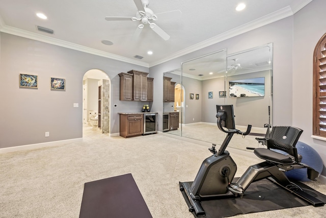 671 Indian River Dr, Melbourne, FL 32935 - exercise room featuring beverage cooler, arched walkways, a ceiling fan, recessed lighting, and crown molding