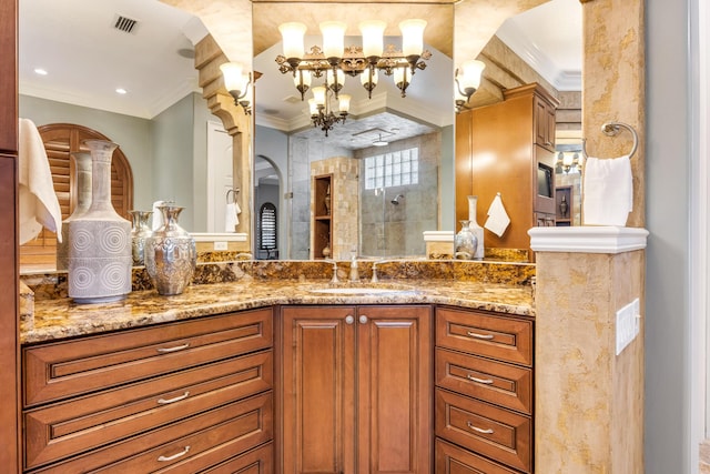 671 Indian River Dr, Melbourne, FL 32935 - bathroom with ornamental molding, vanity, tiled shower, and a chandelier