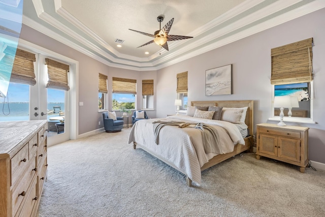 671 Indian River Dr, Melbourne, FL 32935 - bedroom with ornamental molding, a raised ceiling, light carpet, access to exterior, and a ceiling fan