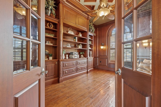 671 Indian River Dr, Melbourne, FL 32935 - unfurnished office featuring a ceiling fan, crown molding, light wood-style flooring, a towering ceiling, and built in features