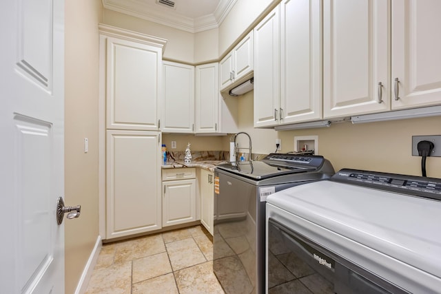 671 Indian River Dr, Melbourne, FL 32935 - washroom with separate washer and dryer, ornamental molding, cabinet space, and light stone finish floors