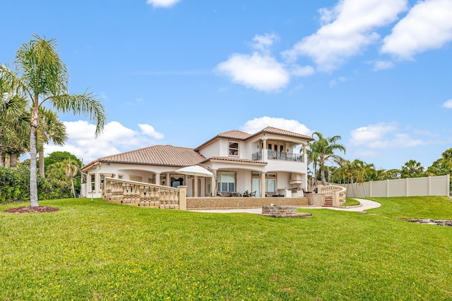 671 Indian River Dr, Melbourne, FL 32935 - rear view of property with a balcony, stucco siding, a tiled roof, and a patio area