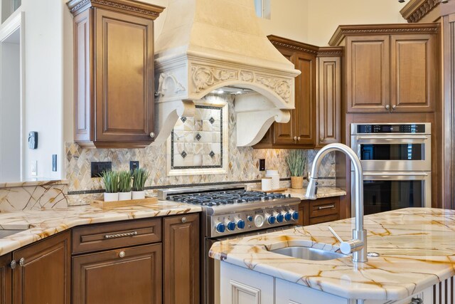 671 Indian River Dr, Melbourne, FL 32935 - kitchen with appliances with stainless steel finishes, decorative backsplash, light stone counters, custom exhaust hood, and brown cabinets