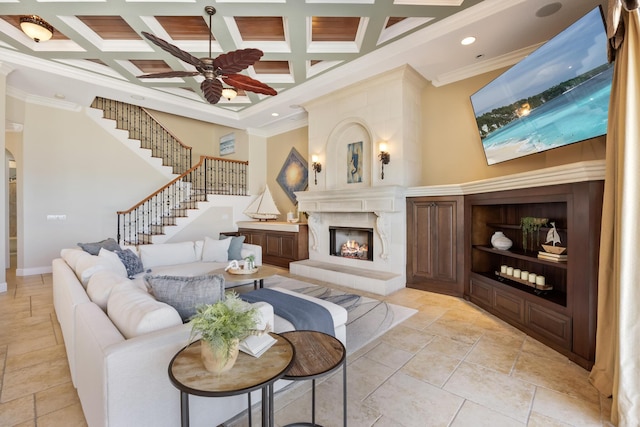 671 Indian River Dr, Melbourne, FL 32935 - living room featuring a large fireplace, ornamental molding, coffered ceiling, a ceiling fan, and stairs
