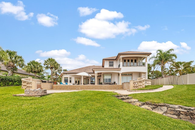 671 Indian River Dr, Melbourne, FL 32935 - back of property featuring a balcony, a tiled roof, and stucco siding