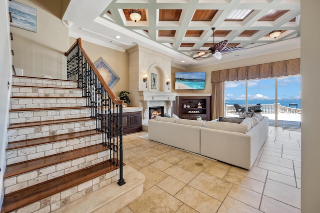 671 Indian River Dr, Melbourne, FL 32935 - living area with ceiling fan, a warm lit fireplace, crown molding, stairway, and beam ceiling