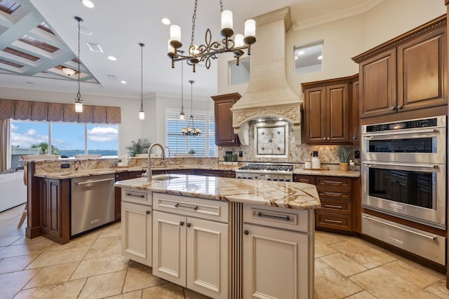 671 Indian River Dr, Melbourne, FL 32935 - kitchen with a chandelier, a warming drawer, stainless steel appliances, tasteful backsplash, and a kitchen island with sink