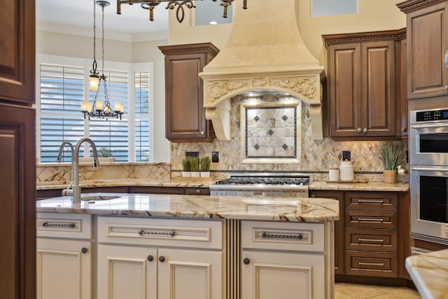 671 Indian River Dr, Melbourne, FL 32935 - kitchen with decorative backsplash, appliances with stainless steel finishes, a chandelier, light stone countertops, and ornamental molding