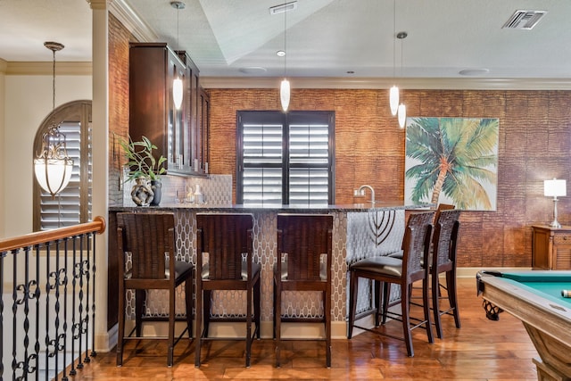 671 Indian River Dr, Melbourne, FL 32935 - indoor wet bar with wood finished floors, crown molding, decorative light fixtures, and billiards
