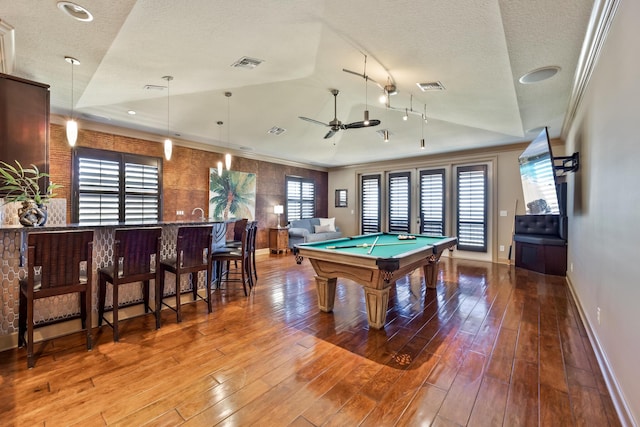 671 Indian River Dr, Melbourne, FL 32935 - playroom with pool table, wood finished floors, a textured ceiling, ornamental molding, and a ceiling fan
