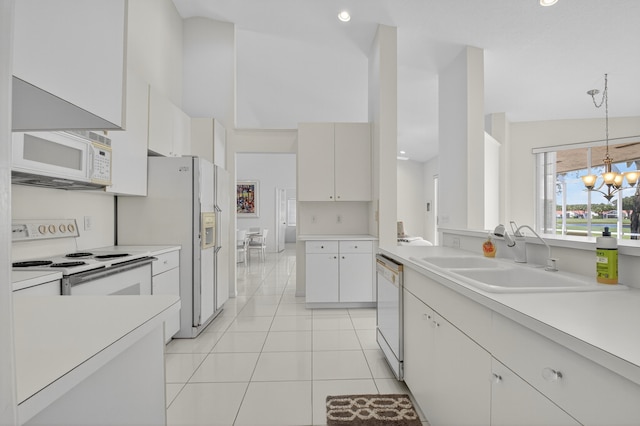 17213 Balboa Point Way, Boca Raton, FL 33487 - kitchen with white appliances, light tile patterned flooring, a chandelier, light countertops, and hanging light fixtures