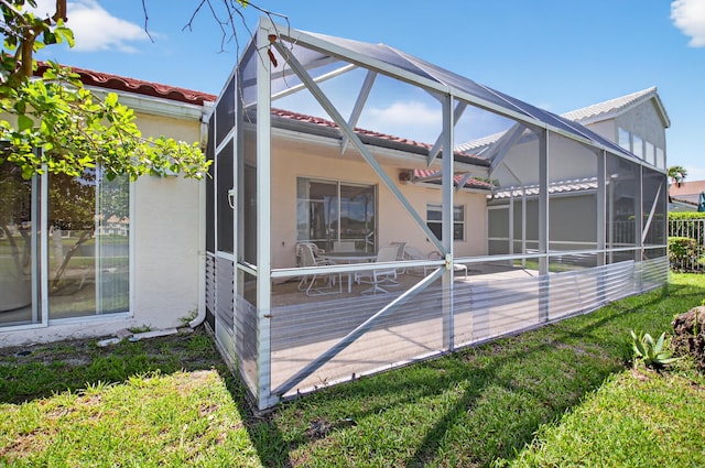 17213 Balboa Point Way, Boca Raton, FL 33487 - back of property with glass enclosure, a tiled roof, stucco siding, a patio area, and a yard