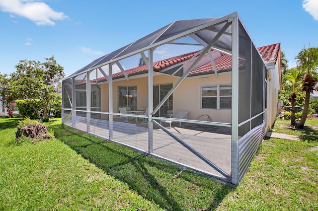 17213 Balboa Point Way, Boca Raton, FL 33487 - back of house featuring a tile roof, a patio area, a yard, stucco siding, and a lanai